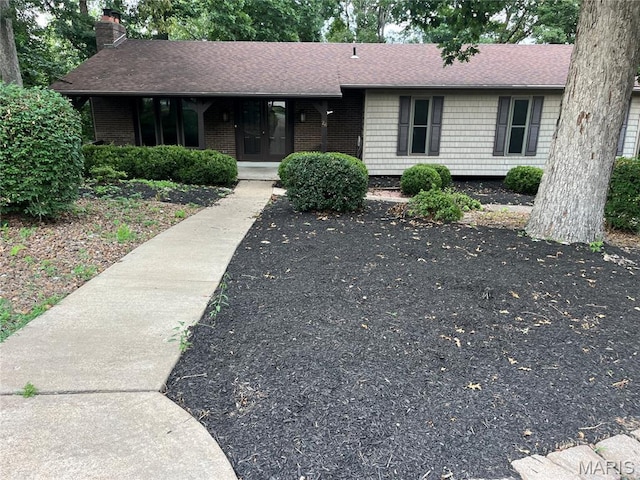 26 Windswept Dr, Arnold, MO 63010 - ranch-style house with a chimney, a shingled roof, brick siding, and covered porch