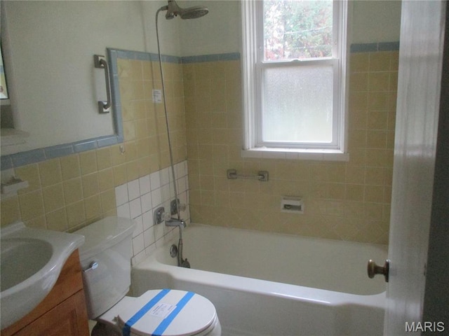 2823 Darwin Ct, Saint Louis, MO 63121 - bathroom featuring vanity, plenty of natural light, tile walls, and shower / washtub combination