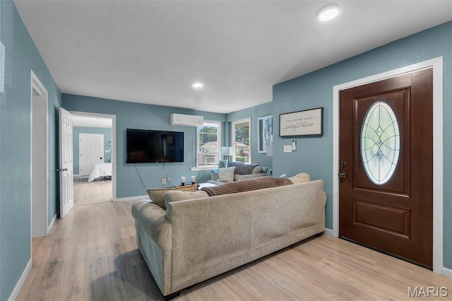 503 Emerson St, Kennett, MO 63857 - living room with light wood-style floors, a wall unit AC, and recessed lighting
