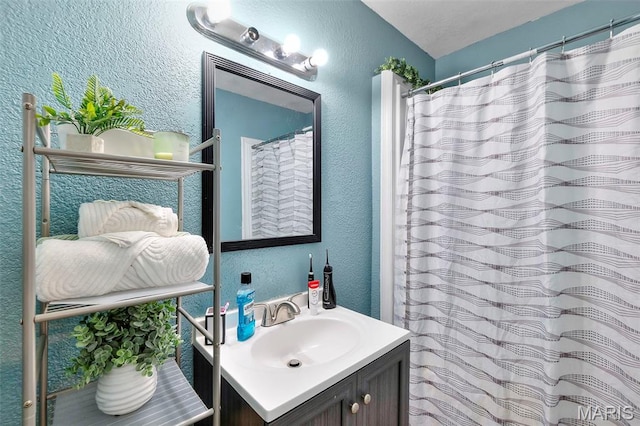 503 Emerson St, Kennett, MO 63857 - bathroom featuring a textured wall, vanity, and a shower with curtain