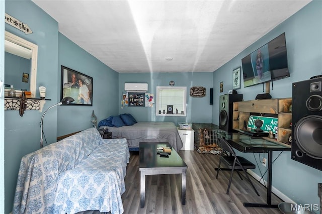 503 Emerson St, Kennett, MO 63857 - living room with wood finished floors and a wall unit AC