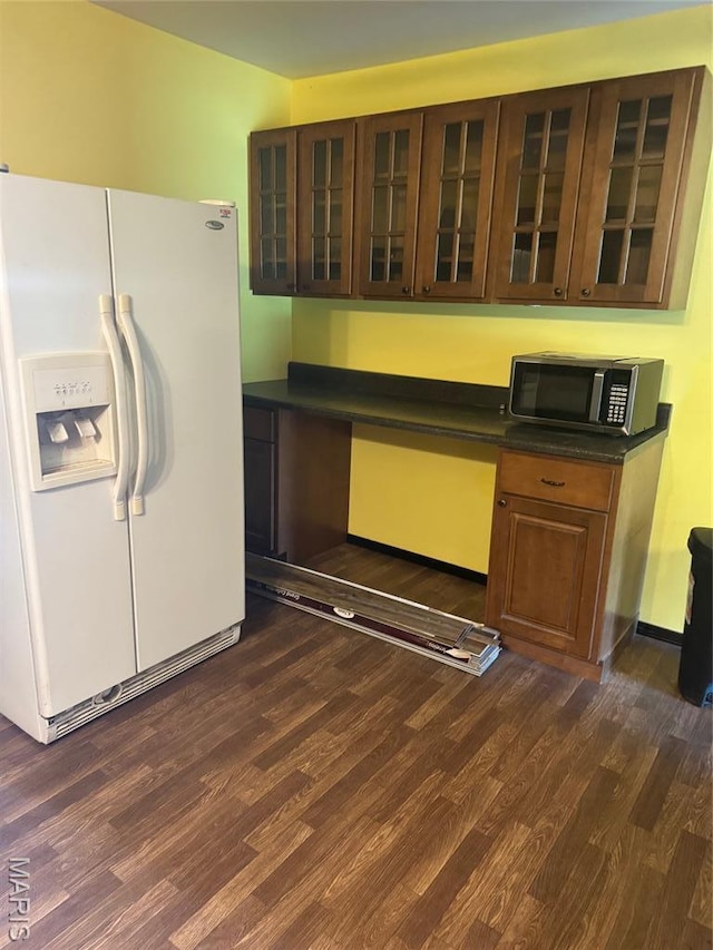 7 N Leota St Unit 7, Dexter, MO 63841 - kitchen with white refrigerator with ice dispenser, stainless steel microwave, dark wood finished floors, and dark countertops