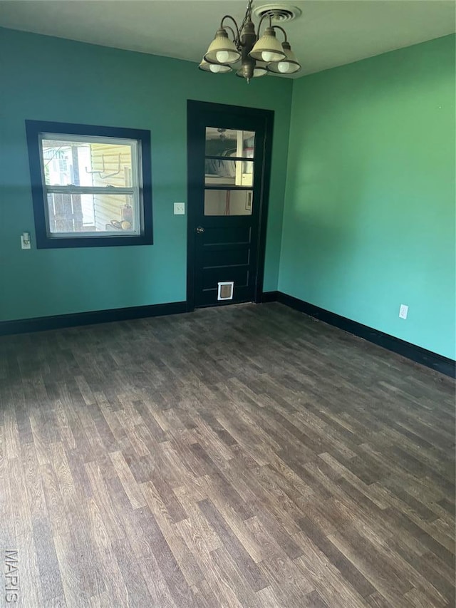 7 N Leota St Unit 7, Dexter, MO 63841 - spare room with dark wood-style flooring and a chandelier