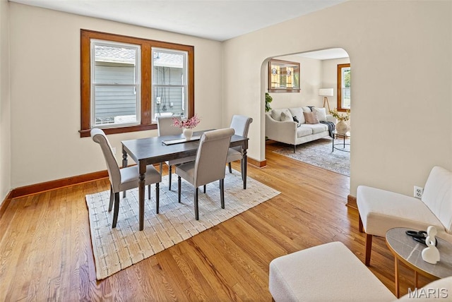 25 S 77th St, Belleville, IL 62223 - dining room featuring arched walkways and light wood-type flooring