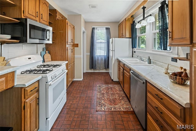 25 S 77th St, Belleville, IL 62223 - kitchen with appliances with stainless steel finishes, open shelves, brick floors, and backsplash