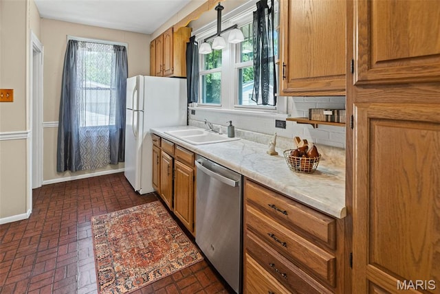 25 S 77th St, Belleville, IL 62223 - kitchen with stainless steel dishwasher, brick floors, freestanding refrigerator, brown cabinets, and light countertops