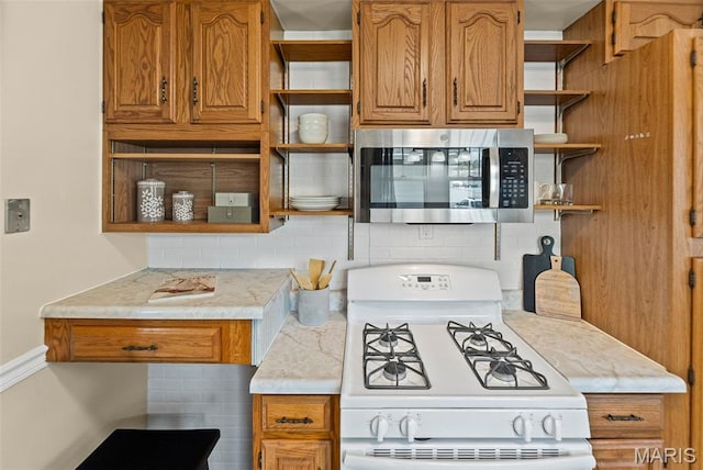 25 S 77th St, Belleville, IL 62223 - kitchen with open shelves, white range with gas cooktop, and stainless steel microwave