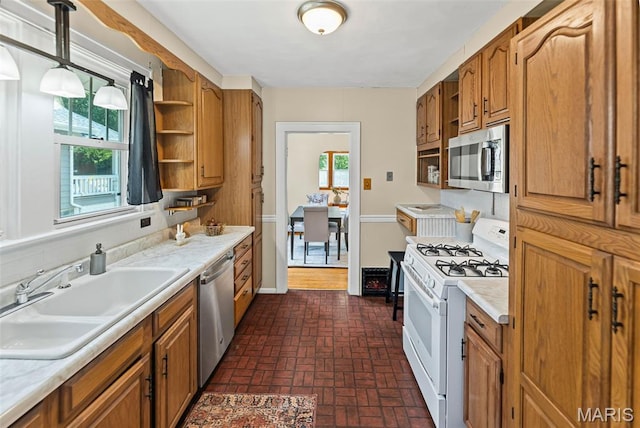 25 S 77th St, Belleville, IL 62223 - kitchen featuring stainless steel appliances, open shelves, brick patterned flooring, and light countertops