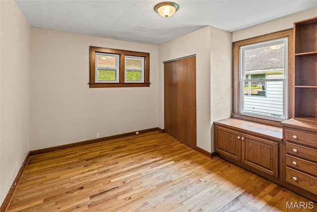 25 S 77th St, Belleville, IL 62223 - unfurnished bedroom with light wood-style flooring and a closet
