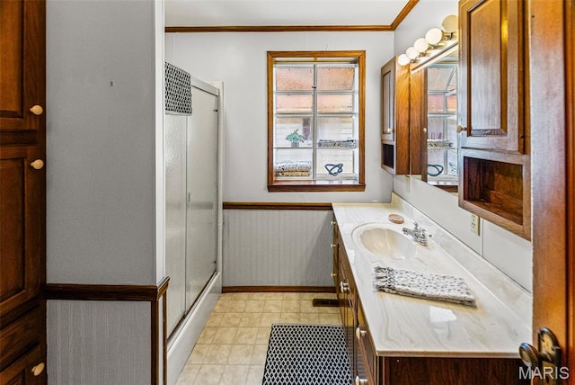 25 S 77th St, Belleville, IL 62223 - bathroom with vanity, a stall shower, wainscoting, and crown molding