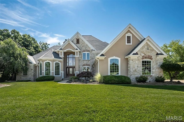 2314 Longest Dr, Wentzville, MO 63385 - french country inspired facade featuring stone siding, stucco siding, and a front yard