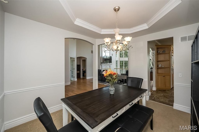2314 Longest Dr, Wentzville, MO 63385 - dining space with arched walkways, a chandelier, ornamental molding, and a raised ceiling