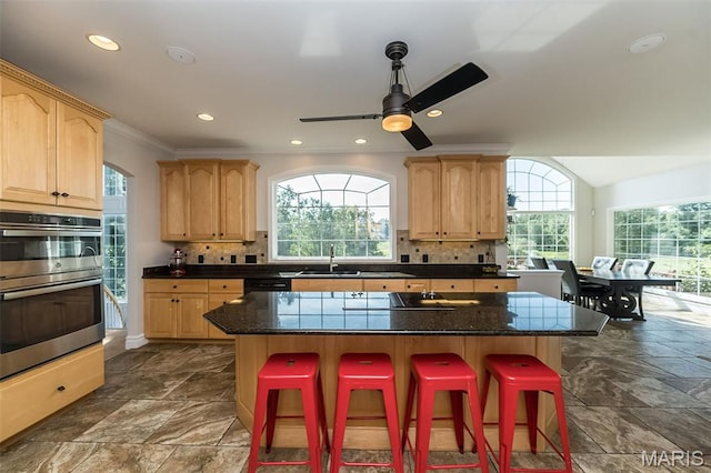 2314 Longest Dr, Wentzville, MO 63385 - kitchen with stainless steel double oven, light brown cabinets, healthy amount of natural light, ornamental molding, and recessed lighting