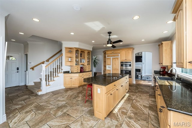 2314 Longest Dr, Wentzville, MO 63385 - kitchen with light brown cabinetry, a ceiling fan, paneled fridge, crown molding, and a center island