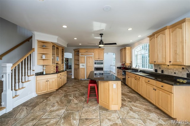 2314 Longest Dr, Wentzville, MO 63385 - kitchen with open shelves, arched walkways, light brown cabinetry, a kitchen island, and recessed lighting