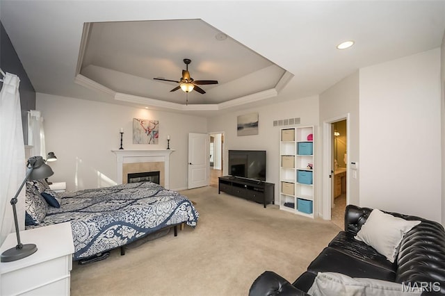 2314 Longest Dr, Wentzville, MO 63385 - bedroom featuring carpet, a tray ceiling, a fireplace, recessed lighting, and ceiling fan