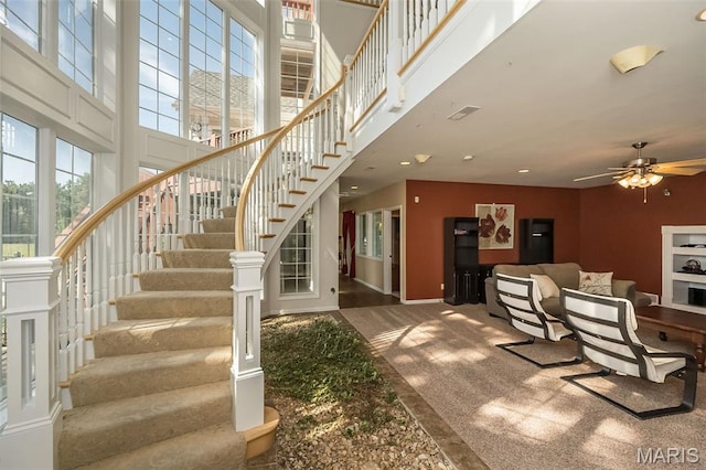 2314 Longest Dr, Wentzville, MO 63385 - stairs featuring a towering ceiling, a ceiling fan, healthy amount of natural light, recessed lighting, and carpet
