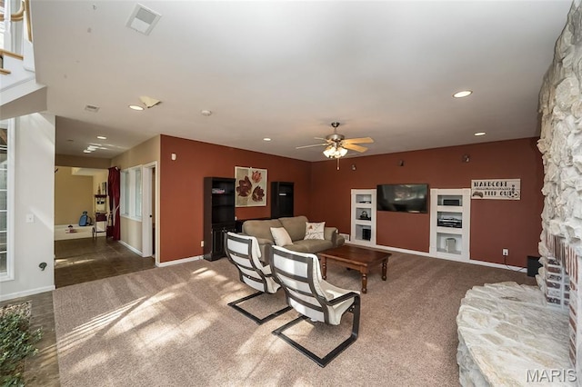 2314 Longest Dr, Wentzville, MO 63385 - carpeted living room featuring ceiling fan, recessed lighting, stairway, and a stone fireplace