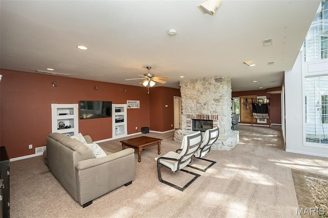 2314 Longest Dr, Wentzville, MO 63385 - carpeted living area with a stone fireplace, ceiling fan, and recessed lighting