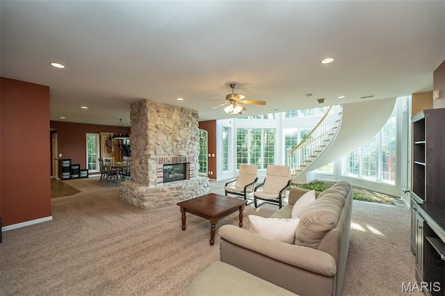 2314 Longest Dr, Wentzville, MO 63385 - carpeted living area featuring a stone fireplace, recessed lighting, ceiling fan, and stairs