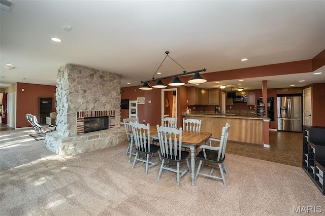 2314 Longest Dr, Wentzville, MO 63385 - carpeted dining area with recessed lighting and a fireplace