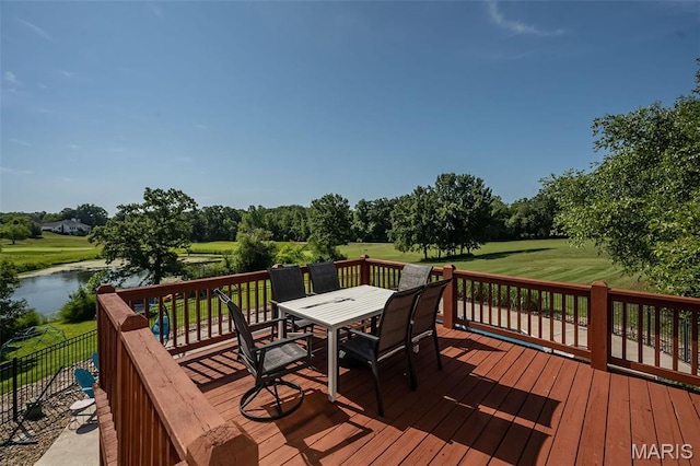 2314 Longest Dr, Wentzville, MO 63385 - wooden deck featuring outdoor dining space, a lawn, a water view, and view of wooded area