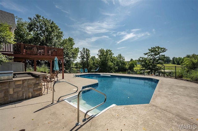 2314 Longest Dr, Wentzville, MO 63385 - view of pool featuring a patio area, a deck, and exterior kitchen