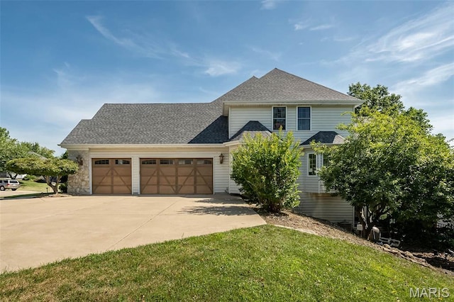 2314 Longest Dr, Wentzville, MO 63385 - traditional-style home featuring an attached garage, driveway, a front lawn, and roof with shingles