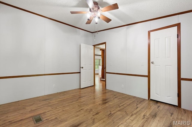 434 Cool Springs Ln, Wright City, MO 63390 - unfurnished room with crown molding, wood finished floors, a ceiling fan, and a textured ceiling