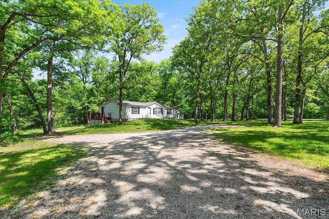 434 Cool Springs Ln, Wright City, MO 63390 - view of front of house with a front lawn, a forest view, and driveway