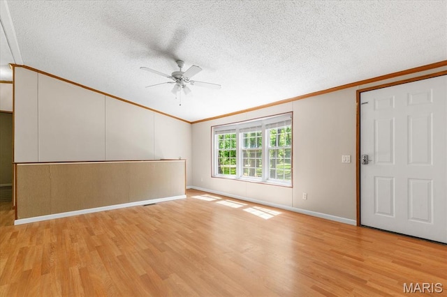 434 Cool Springs Ln, Wright City, MO 63390 - spare room featuring crown molding, lofted ceiling, light wood-style flooring, ceiling fan, and a textured ceiling