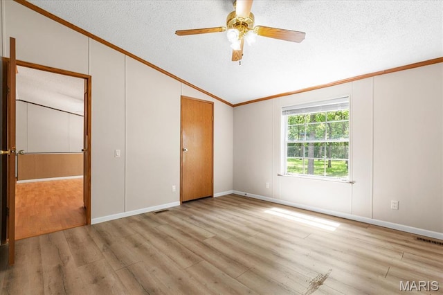 434 Cool Springs Ln, Wright City, MO 63390 - unfurnished bedroom featuring crown molding, lofted ceiling, a textured ceiling, wood finished floors, and a ceiling fan