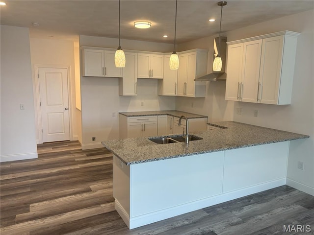 314 Captains Ct, Grafton, IL 62037 - kitchen featuring wall chimney exhaust hood, dark wood-type flooring, stone counters, recessed lighting, and a peninsula