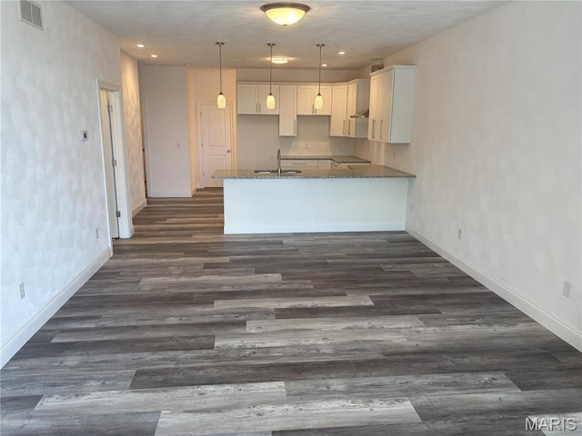 314 Captains Ct, Grafton, IL 62037 - kitchen featuring dark wood-style flooring, white cabinetry, a peninsula, dark stone counters, and recessed lighting