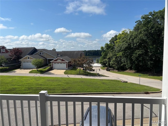 314 Captains Ct, Grafton, IL 62037 - view of grassy yard featuring driveway and a garage