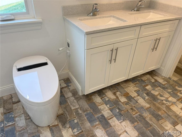 314 Captains Ct, Grafton, IL 62037 - bathroom featuring baseboards and double vanity