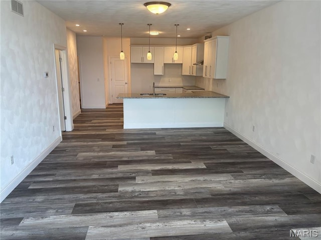 314 Captains Ct, Grafton, IL 62037 - kitchen with dark wood-style flooring, white cabinets, dark stone countertops, a peninsula, and recessed lighting