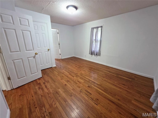 123 W Wickliffe Ave, Collinsville, IL 62234 - unfurnished bedroom featuring wood finished floors and a textured ceiling