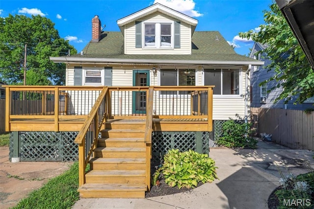 2733 Hermitage Ave, Saint Louis, MO 63143 - view of front of house with a wooden deck, a shingled roof, a chimney, and stairway