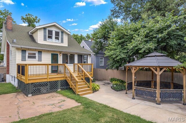 2733 Hermitage Ave, Saint Louis, MO 63143 - view of front facade featuring a patio, a gazebo, a chimney, and a wooden deck