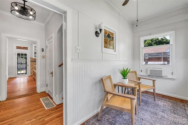 2733 Hermitage Ave, Saint Louis, MO 63143 - hall featuring crown molding, light wood finished floors, cooling unit, a decorative wall, and stairway