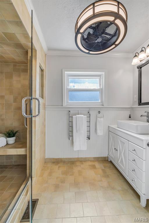 2733 Hermitage Ave, Saint Louis, MO 63143 - bathroom with crown molding, a stall shower, vanity, and wainscoting