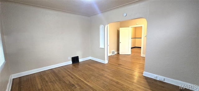 6128 Bircher St, Saint Louis, MO 63120 - empty room with wood finished floors and arched walkways