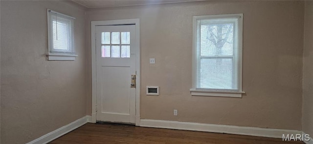 6128 Bircher St, Saint Louis, MO 63120 - entryway with baseboards and dark wood-style flooring