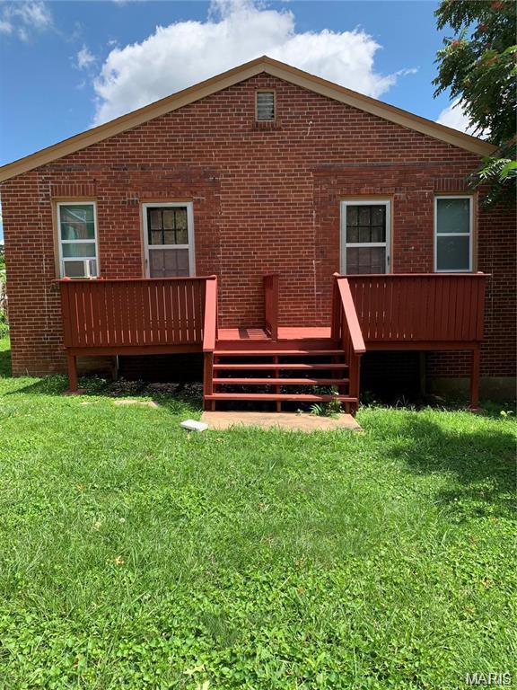 6128 Bircher St, Saint Louis, MO 63120 - back of house featuring a yard, brick siding, and a deck