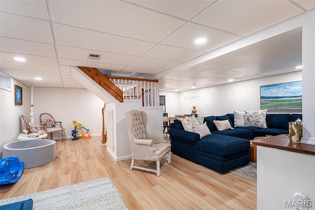 107 Huntleigh Dr, Kirkwood, MO 63122 - living area with wood finished floors, a paneled ceiling, stairs, and recessed lighting