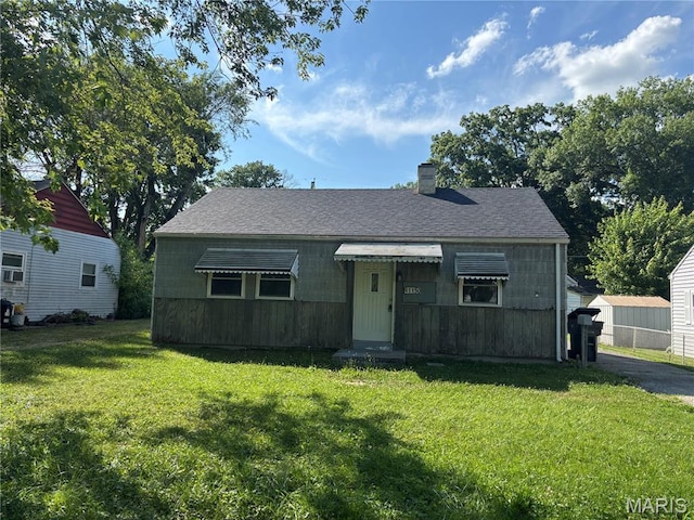 1150 Wabash Ave, Belleville, IL 62220 - bungalow-style home featuring a front lawn, a chimney, and roof with shingles