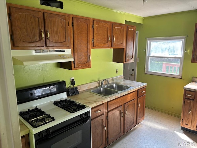 1150 Wabash Ave, Belleville, IL 62220 - kitchen with gas stove, under cabinet range hood, light countertops, brown cabinets, and crown molding