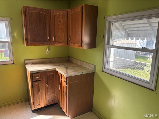1150 Wabash Ave, Belleville, IL 62220 - kitchen with light countertops, light flooring, and brown cabinetry