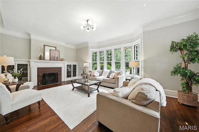 6336 Pershing Ave, University City, MO 63130 - living area featuring dark wood-type flooring, ornamental molding, a brick fireplace, and a chandelier